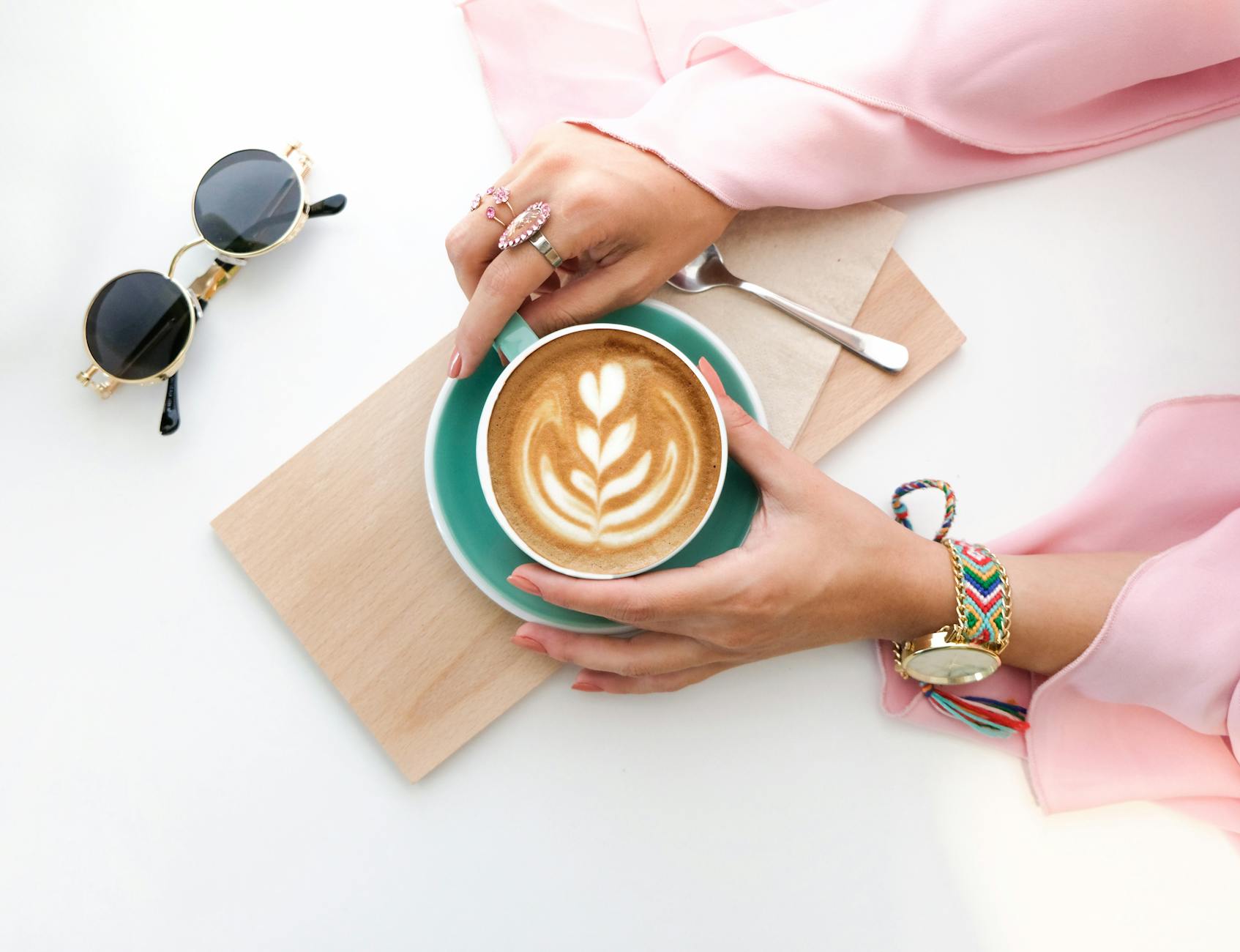woman holding cup of latte