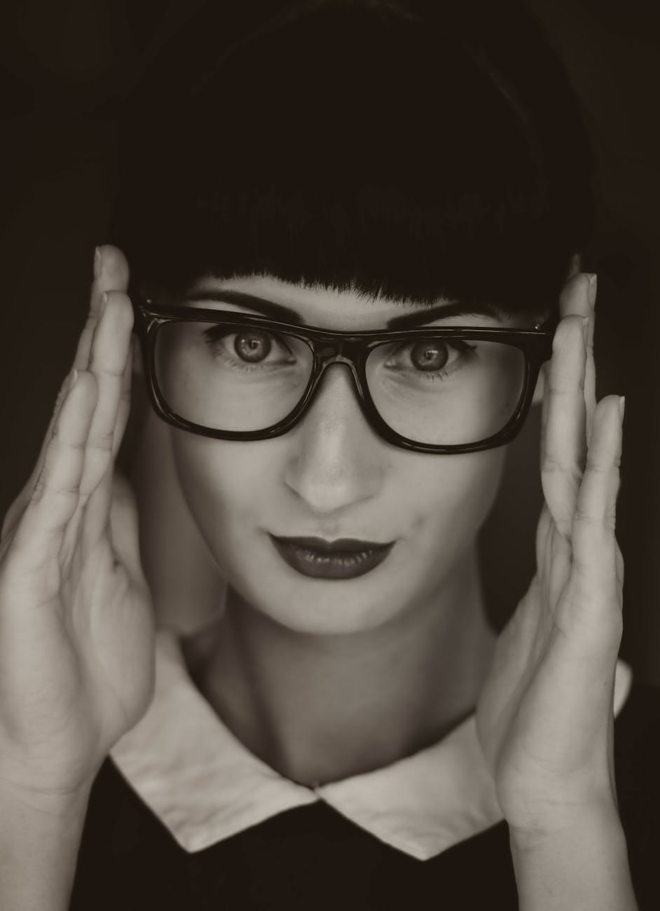 grayscale photography of woman wearing eyeglasses