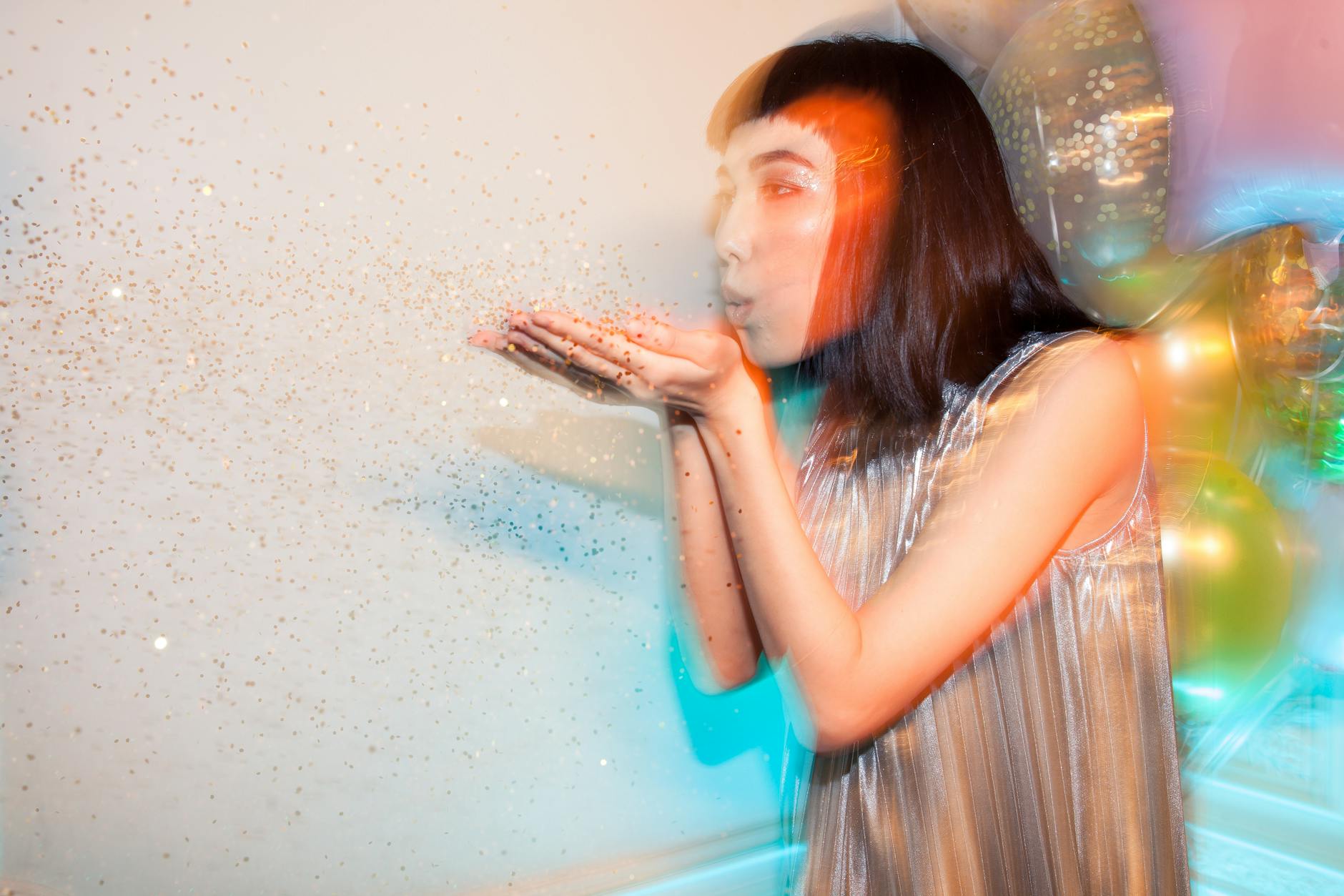 woman blowing glitters