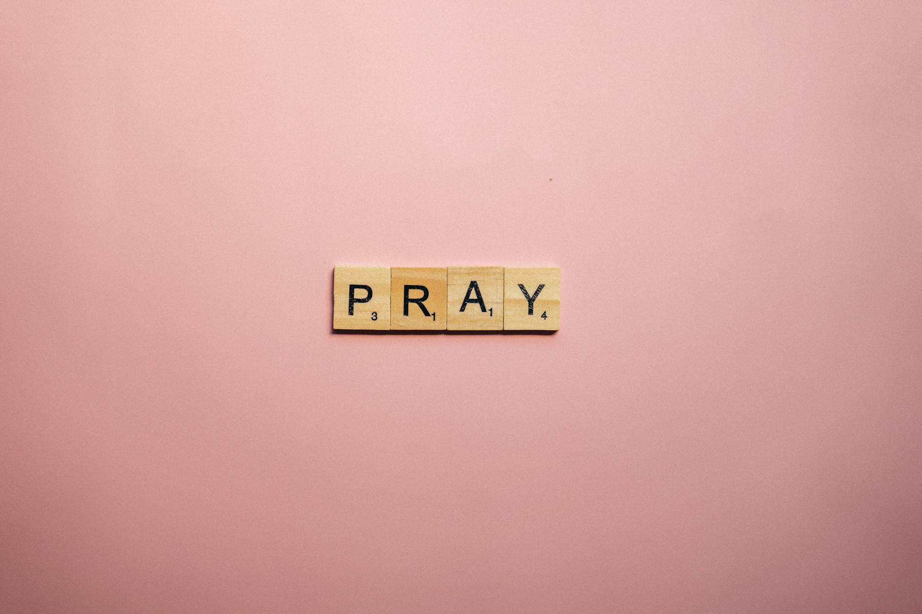 scrabble tiles on pink surface