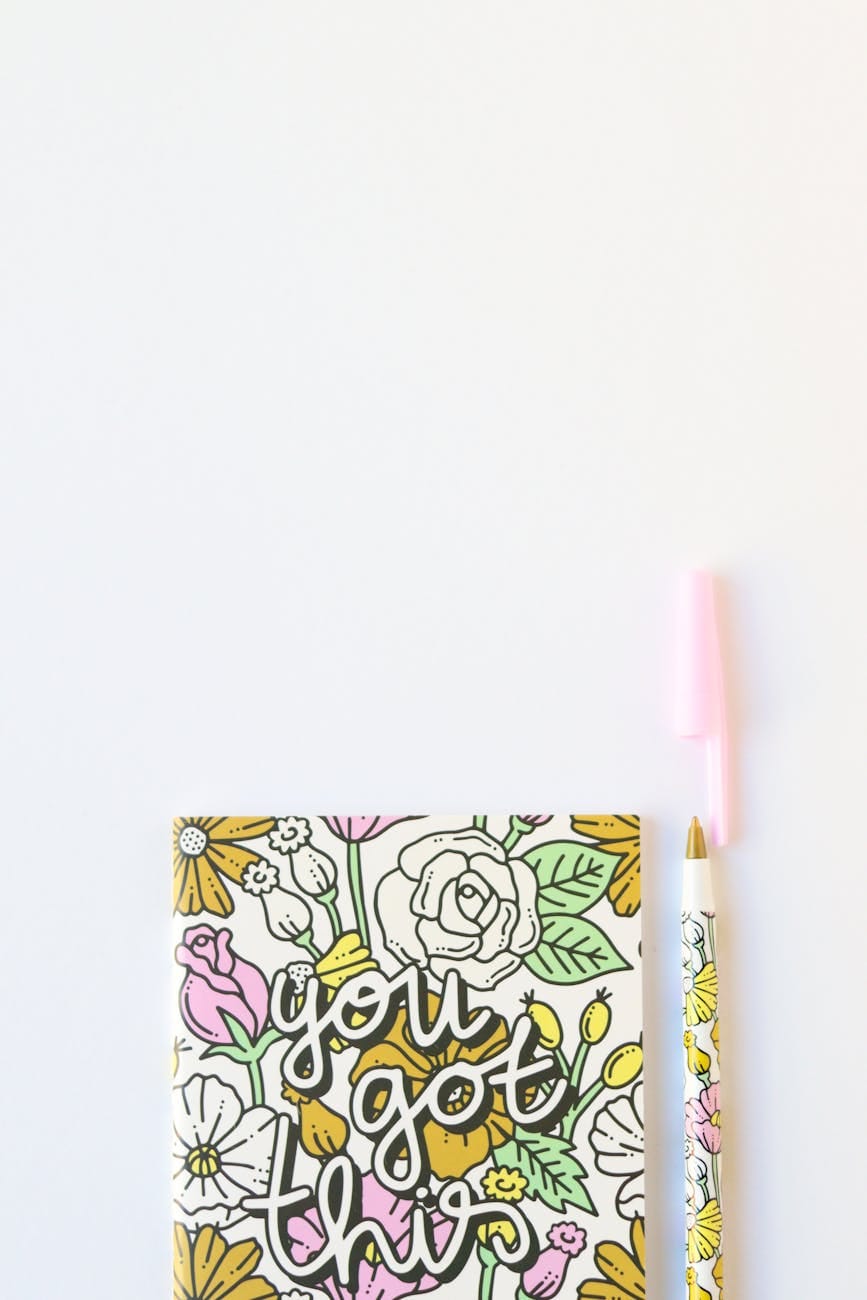 notebook beside a pen