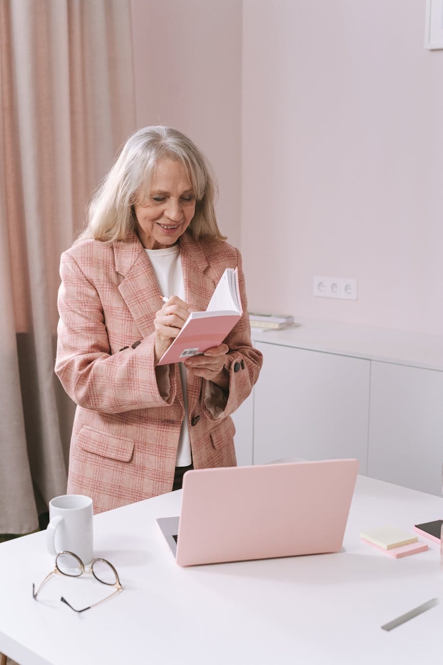 woman standing by the table taking notes