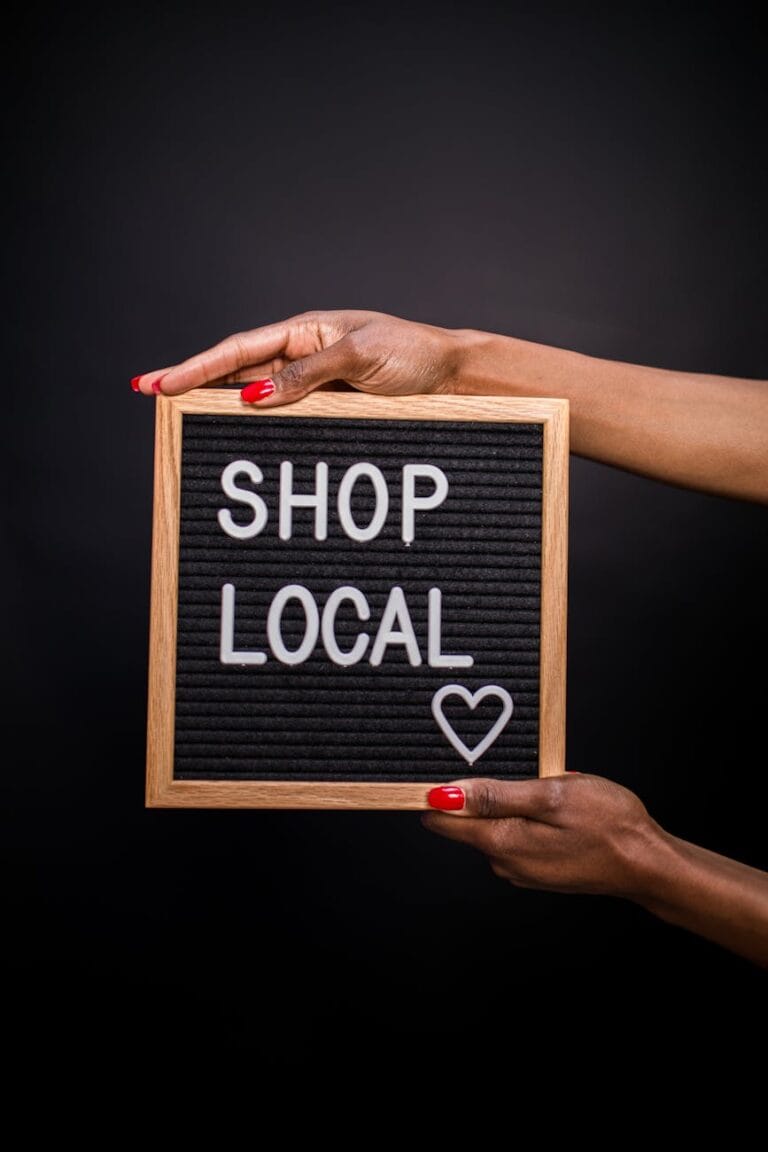 a person holding a letter board with shop local text