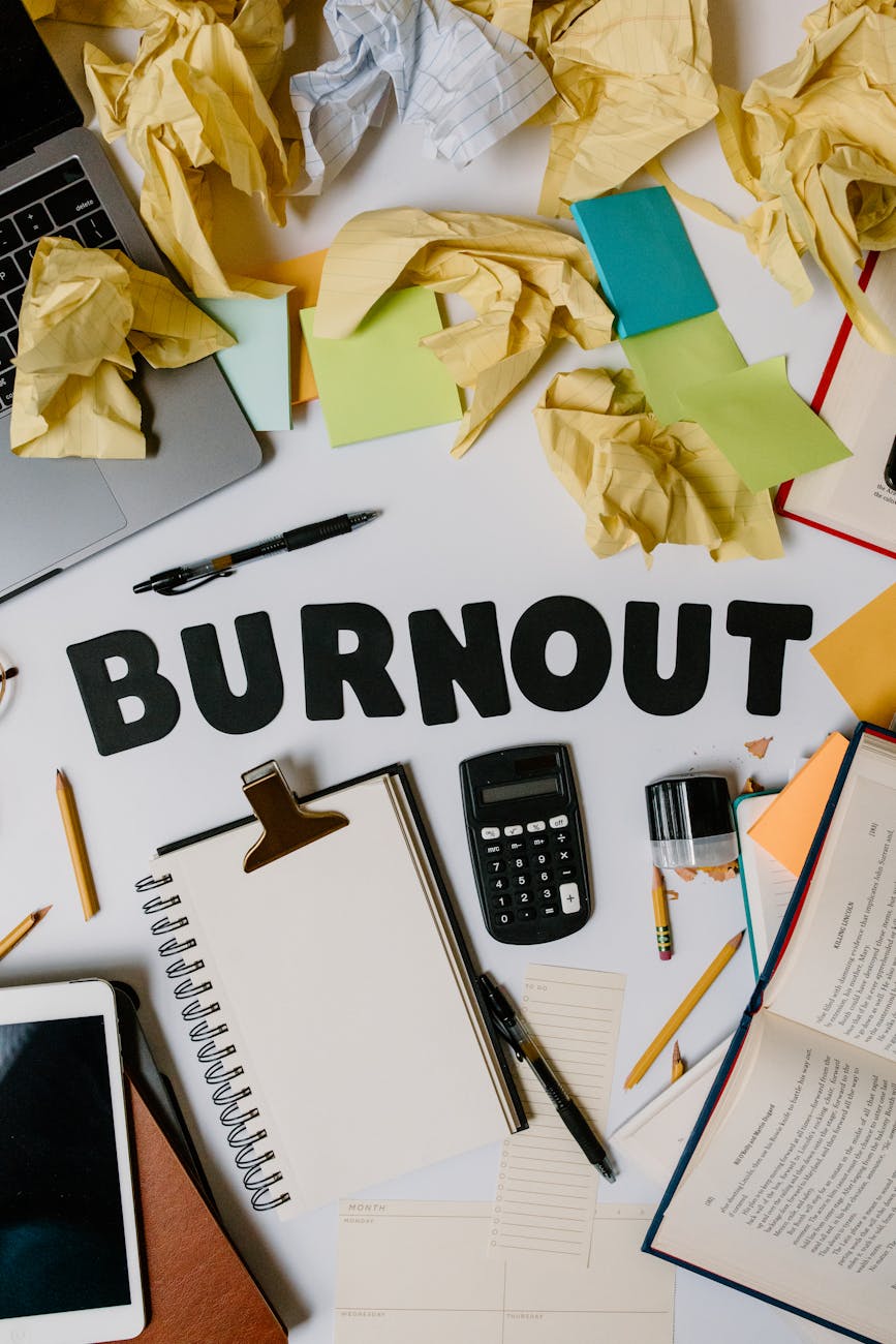 black letters surrounded with office supplies and crumpled papers