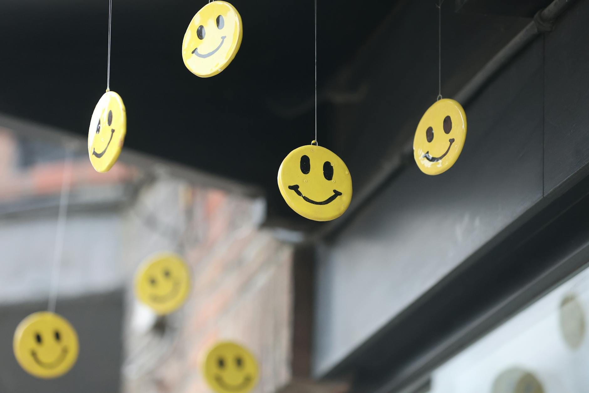 hanging yellow smiley faces in outdoor setting